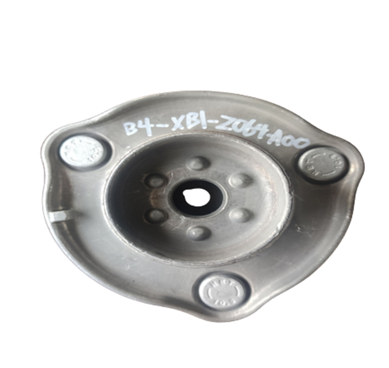Top strut mount component close up showing metal and rubber construction