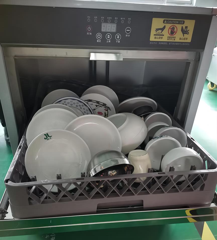 Dishwasher with open door showing internal rack and loading capacity