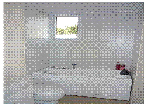 Freestanding White Bathtub with Chrome Fixtures