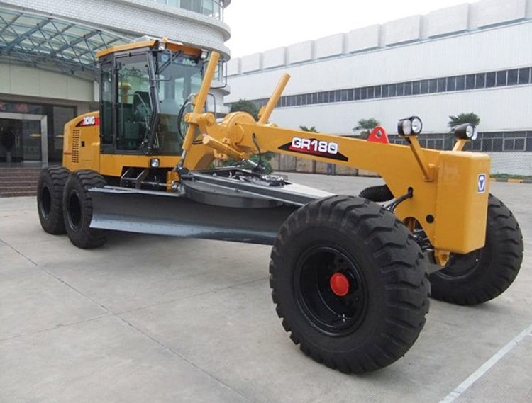 Front view of the motor grader showing blade and cabin