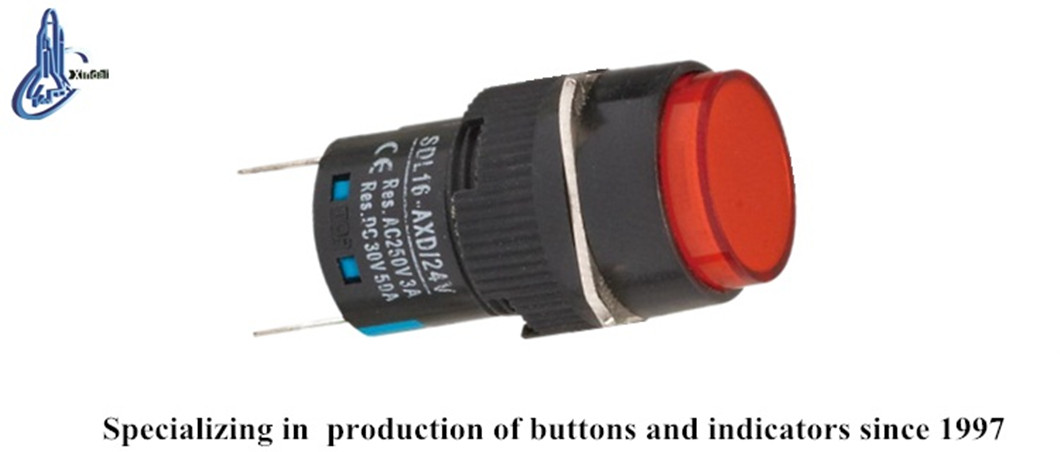 Miniature LED pushbutton switch installed in a control panel environment.