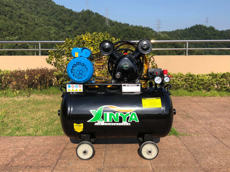 Air compressor showing pressure gauges, regulator, and wheels
