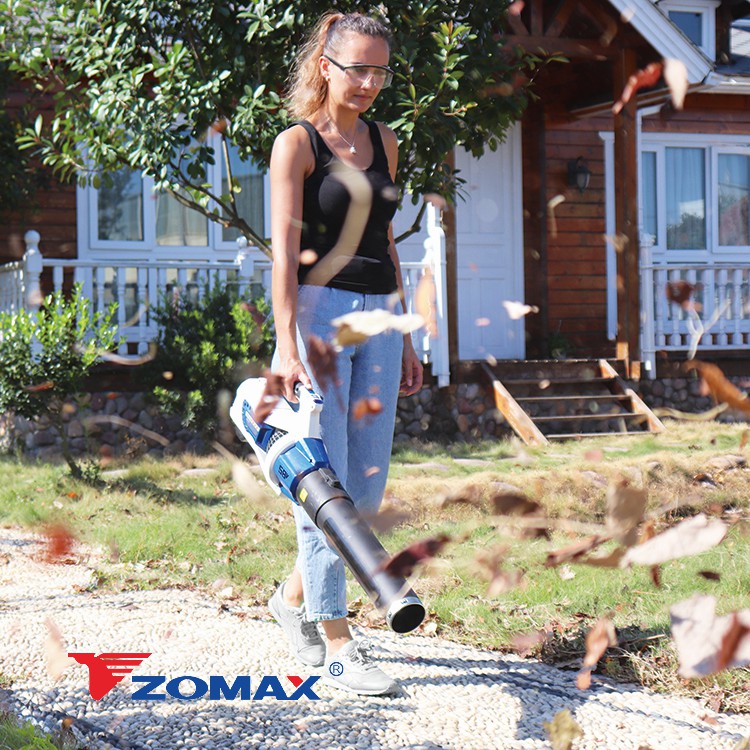 Leaf blower held by a user in an outdoor setting