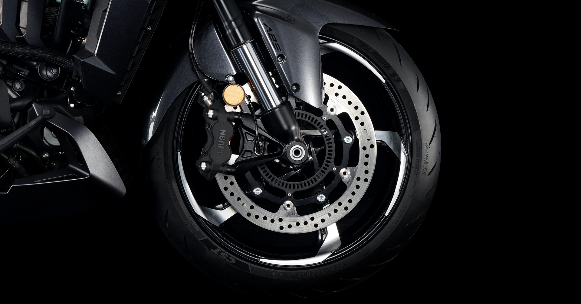 Close-up of front wheel assembly and braking components