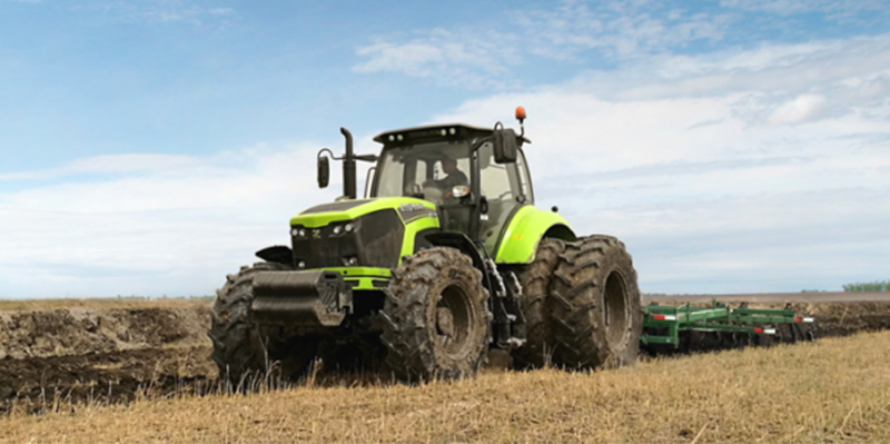 Full view of the 230HP tractor in a field setting